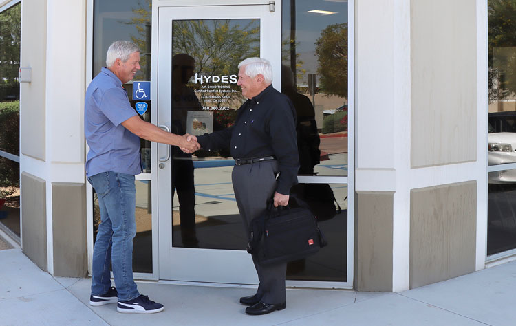 Jerry J. Goldstein shaking hands with a client